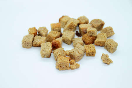 Golden rye crackers are located on a white backgroundの写真素材