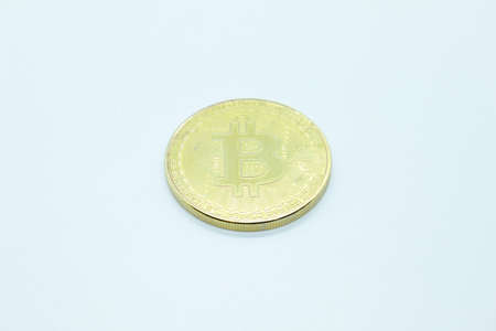 Metallic physical bicoin located on a white backgroundの写真素材