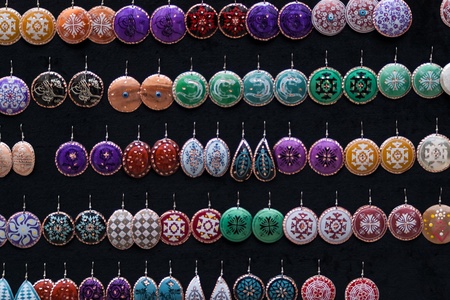 Set of round and ellipse silber earrings with glaze on the black textile backgroundの写真素材