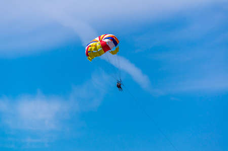 Two people on the parachute in the blue skyの写真素材