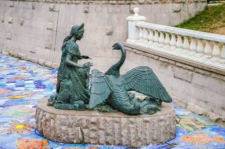 Young lady and Swan sculpture in Moscow, Russiaの写真素材