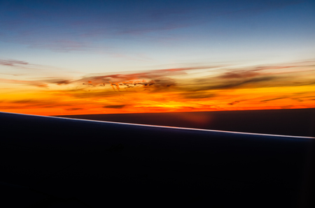 Sunset view in flight from airplane windowの写真素材