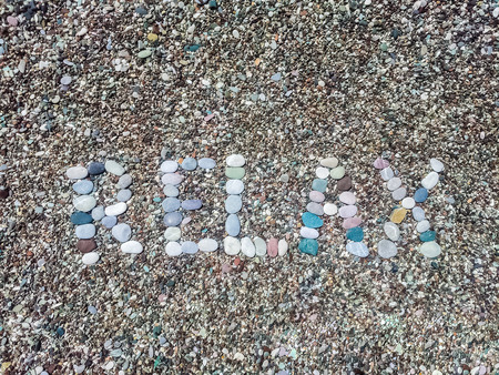 Relax word from stones on pebble beach in Montenegro