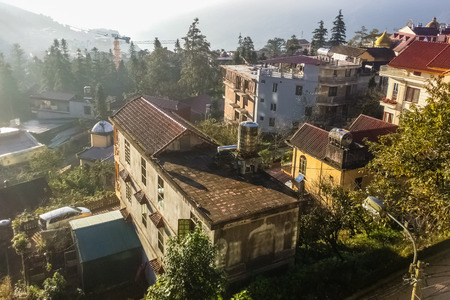 SAPA, VIETNAM - NOVEMBER 16: Top view on the village at sunrise at November 16, 2016 in Sapa,...