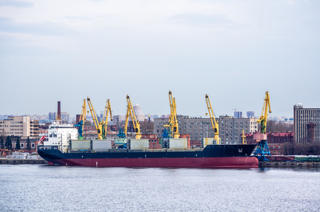 SAINT-PETERSBURG, RUSSIA - APRIL 17: Evening view on sea port, ships and cranes at April 17, 2016 in Saint-Petersburg, Russiaのeditorial素材