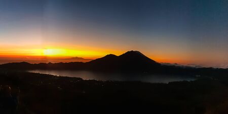 Amazing panorama view on sunrise and mountain from summit of Batur volcano, Bali, Indonesiaの写真素材