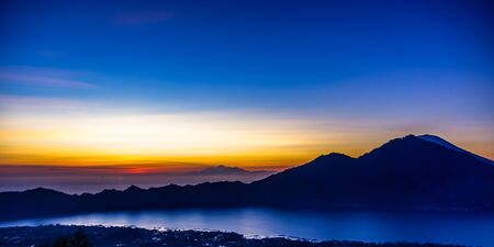 Amazing panorama view on sunrise and mountain from summit of Batur volcano, Bali, Indonesiaの写真素材