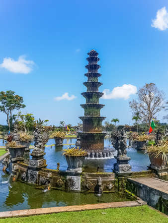 Fontain tower in the pond in Tirta Gangga temple at sunny day, Bali, Indonesia
