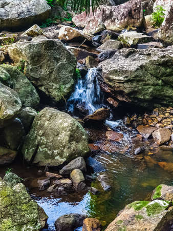 Waterfall and mountaina river in the Yanoda Rainforest Cultural Tourism Zone, Hainan, China