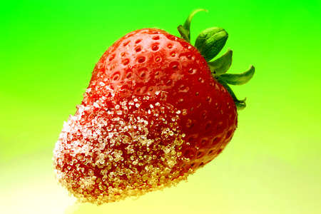 Juicy strawberry close-up dipped in sugarの写真素材