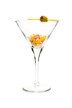 DRUG COCKTAIL - A cocktail glass with an olive, filled with pills and capsules.の写真素材