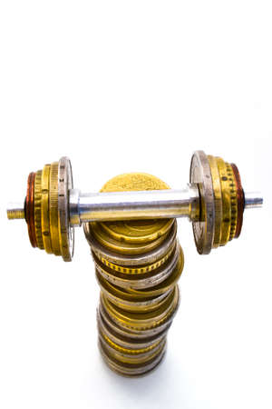 ECONOMIC STRENGTH 3 - A euro-coin-weight-lift on the top of a pile of coins.の写真素材
