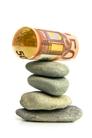 EURO BALANCING 2 - A 50 euro note attempting to balance on top of stones in a zen-fashion.の写真素材