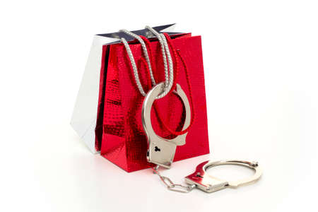 FASHION VICTIM - Two glamorous shopping bags got ?arrested? with handcuffs.の写真素材