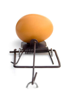 LOSE-LOSE SITUATION -  A mouse-trap using an egg as a bait. Attempting to get the egg will result in broken egg. Not attempting at all, will result in no egg at all. Lose-lose situation.の写真素材