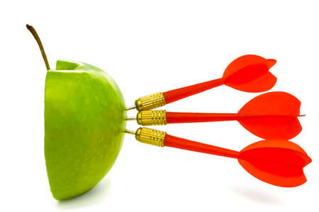 TRIPLE BULLSEYE 4 - Three red darts-arrows hit a half cut green apple.の写真素材