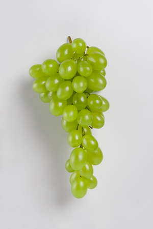 Bunch of fresh green grapes isolated on whiteの写真素材