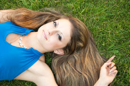 Young Woman Lying On The Grassの写真素材