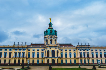 Daytime photo of Charlottenburg Palace in Berlin Germany with baroque architecture, central dome and statues, historic landmark and major tourist attraction.の写真素材