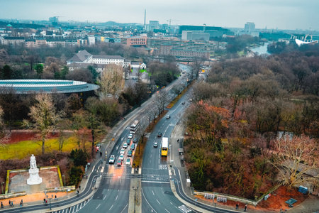 Scenic aerial view of Tiergarten park in Berlin Germany with colorful winter trees, busy streets, statue and modern city buildings visible in the distance.の写真素材