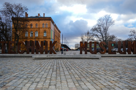 Exterior view of the German Museum of Technology in Berlin, Germany, featuring large metal letters âTECHNIK MUSEUMâ at the entrance and a historic brick building behind.の写真素材