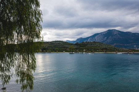 Scenic coastal view from Saint Nicholas Church in Epidaurus, Greece, with turquoise sea, olive groves, and mountains creating a peaceful Mediterranean landscape.の写真素材
