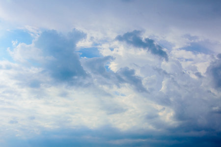 Calm sky with soft white cumulus clouds and blue gradients. Ideal for nature, design backgrounds, or...