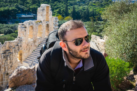 Man posing at Herodes Atticus Odeon in Acropolis, Athens, Greece.の写真素材