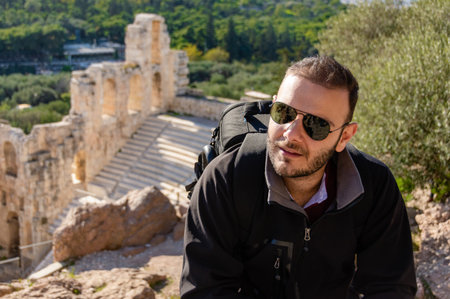 Man at Odeon of Herodes Atticus ancient theater in Athens, Greece.