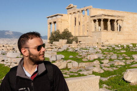 Traveler at Erechtheion temple with Caryatids on Acropolis in Athens, Greece.の写真素材