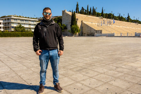 Man standing in front of Panathenaic Stadium in Athens, Greece, landmark.の写真素材