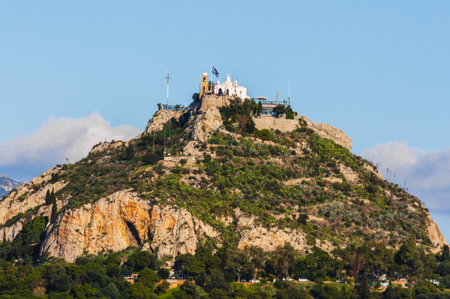 Lycabettus Hill with Saint George church and Greek flag in Athens, Greece.の写真素材