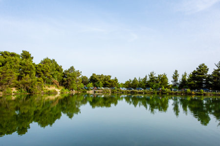 Panoramic view of Beletsi Lake with forest reflection in Attica, Greece.の写真素材