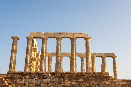 Temple of Poseidon ruins under blue sky in Sounion, Attica, Greece.