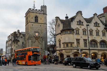 Oxford city street with bus and historic buildings.