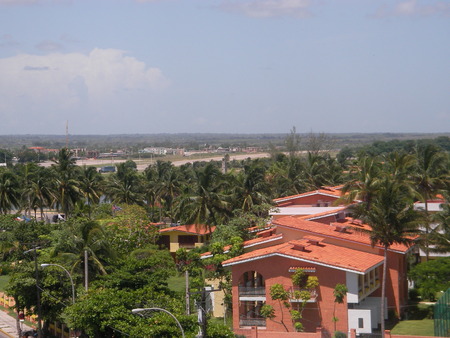 View of the Caribbean Sea with palm trees and lodges on the island Cubaの写真素材