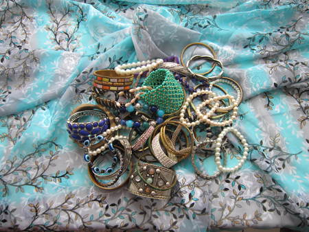 Various jewelry from a tree, pearls, gold, plastic and stones is collected in one heapの写真素材