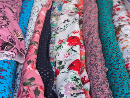 Rolls of colorful fabrics for tailoring of curtains and dresses