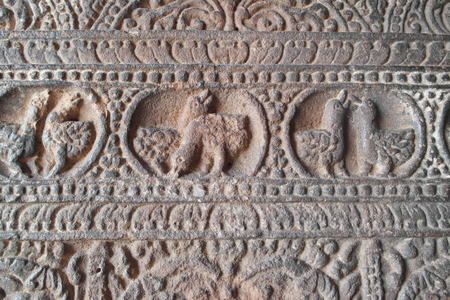Ornament on walls and columns in the group of temples in the city of Pattadakal in Indiaの写真素材