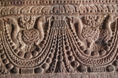 Ornament on walls and columns in the group of temples in the city of Pattadakal in India