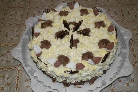 Festive beautiful and delicious cake decorated with cream flowersの写真素材