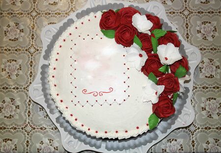 Festive beautiful and delicious cake decorated with cream flowersの写真素材