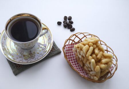 Cup of black freshly brewed coffee with sweets