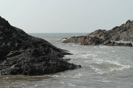 Rocks from volcanic rock on ocean beachの写真素材