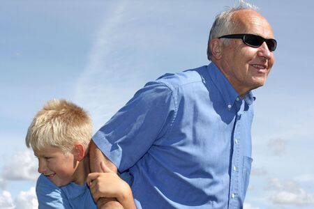 Grandfather and grandson playingの写真素材