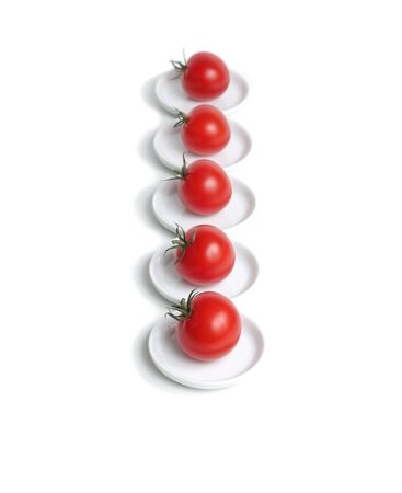 Five red organic  tomato on platesの写真素材