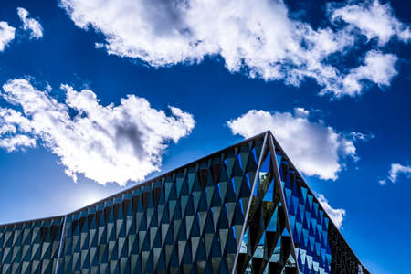 Modern architecture building with mirrors. Sky with clouds on the backgroundのeditorial素材