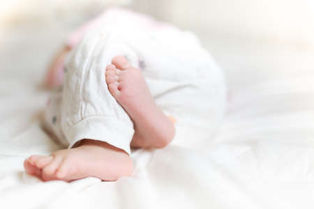 Cute little baby sleeping on bed at homeの写真素材