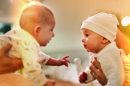 Two infant babies are very interested in each other. Learn.の写真素材
