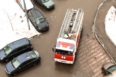 Problem. The special fire truck cannot drive in the courtyard of a multi-storey high-rise building because of parked cars. View from above.の写真素材